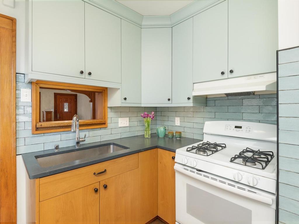 The attractive subway tile is of similar hue as the upper cabinets, providing a seamless and visually appealing aesthetic.