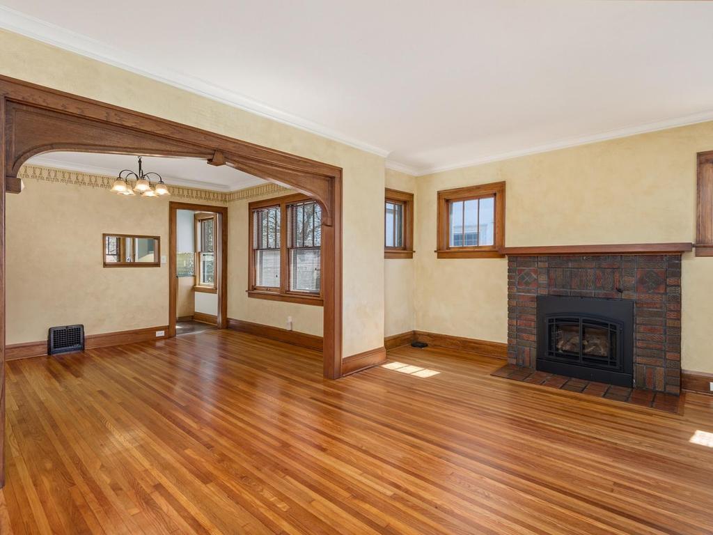 The Living Room opens into Dining Room with an ornate archway unique to this period.