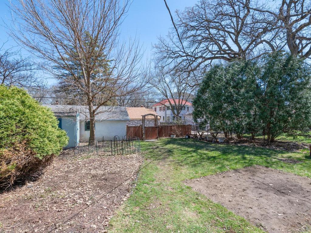 Fenced Backyard features plenty of planting space for your own flower/vegetable gardens or a new dream landscape design to fit your needs!