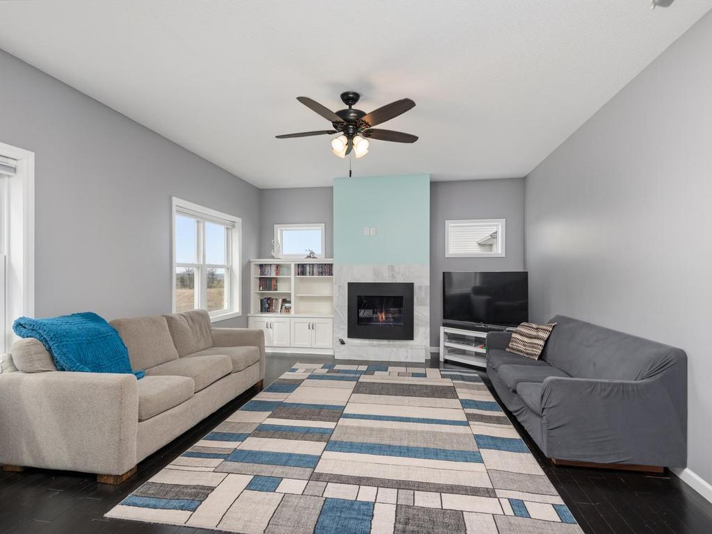 Spacious Living Room with gas fireplace & custom built-ins.