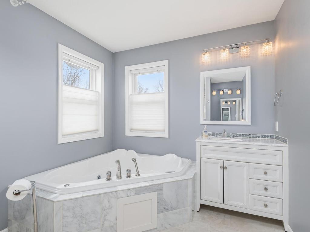 Two vanities, jetted tub, and separate step-in shower complete the calming Primary Bath.