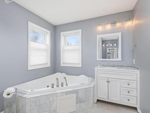Two vanities, jetted tub, and separate step-in shower complete the calming Primary Bath.