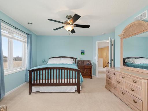 Upper level Primary Suite has a walk-in closet with built-in shelving and a private Full Bath.