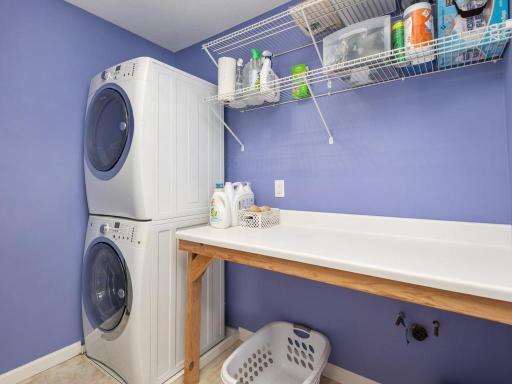 Upper level Laundry Room with folding counter & shelving has a rough-in for a utility sink.
