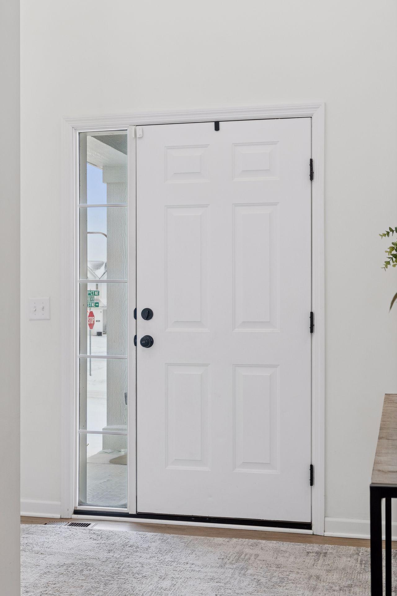 Insulated front entry door with full side light overlooking front porch.