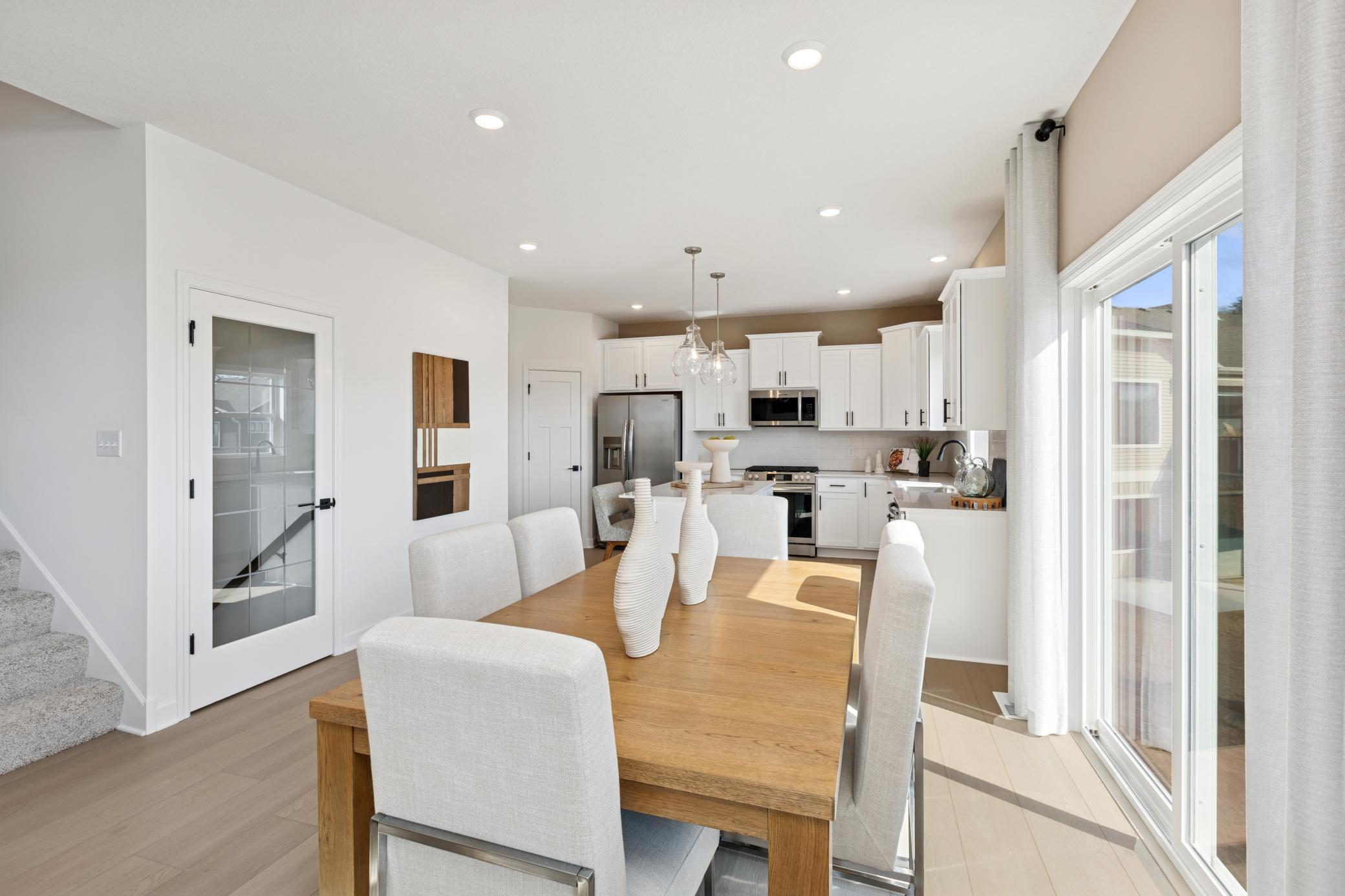 (Photo of Actual Model Home) The dining room is situated among the open floorplan, making it easy to move between the kitchen and Great Room.
