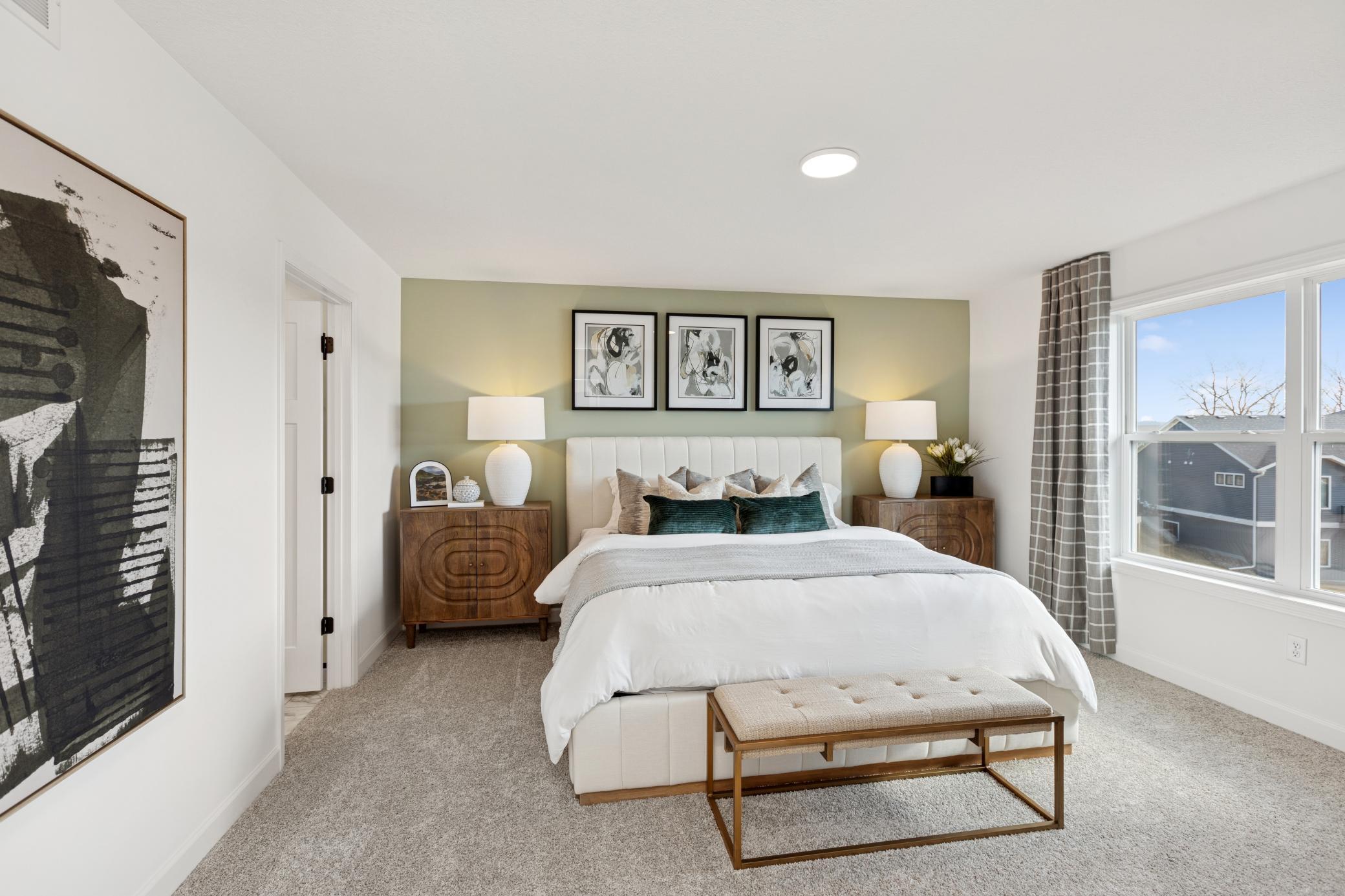 (Photo of Actual Model Home) The owner’s suite is situated on the home’s second level, comprised of a restful bedroom, en-suite bathroom and walk-in closet.