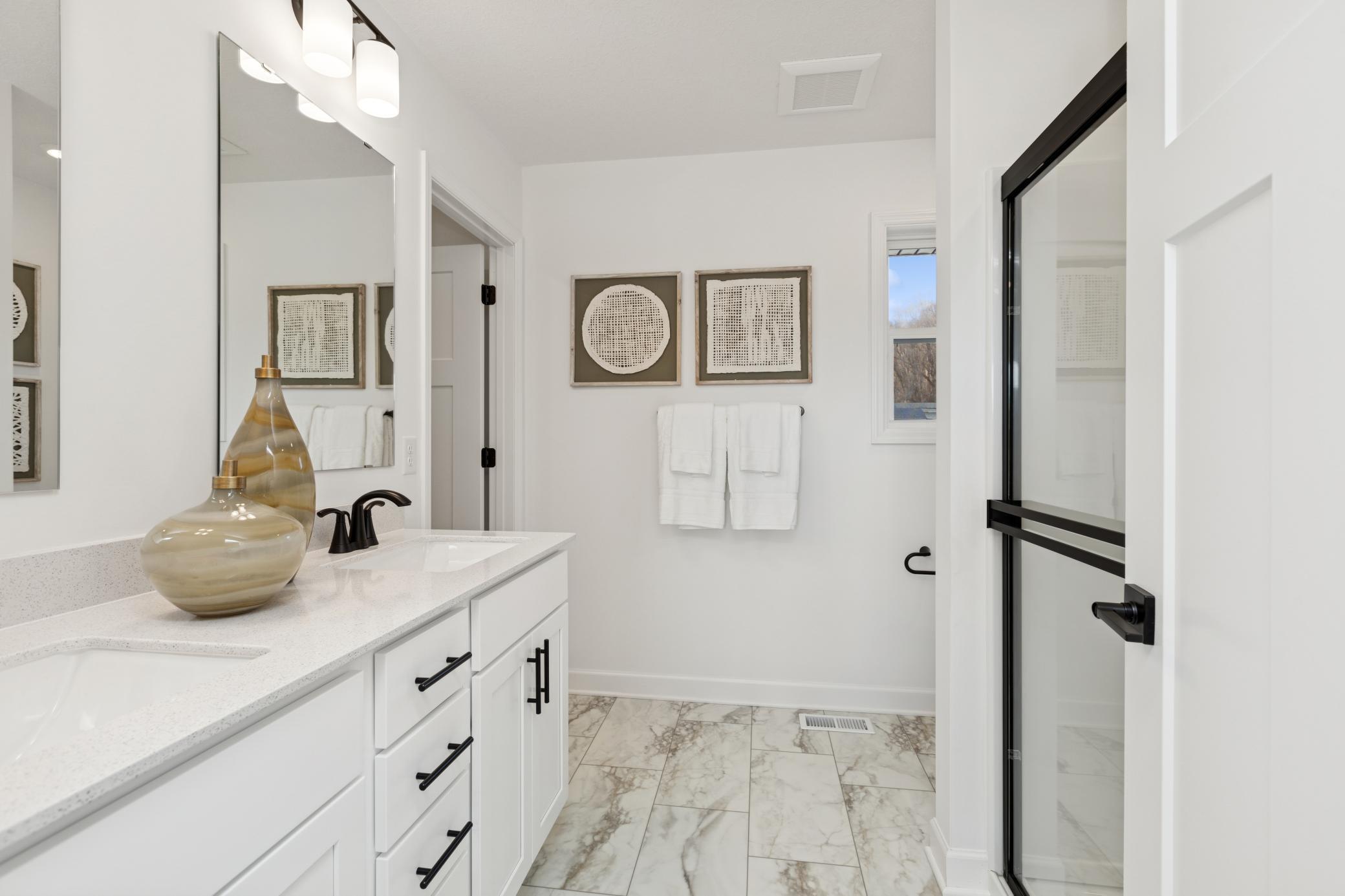 (Photo of Actual Model Home) Rectangular dual sinks at this spacious quartz-topped vanity promote streamlined morning routines