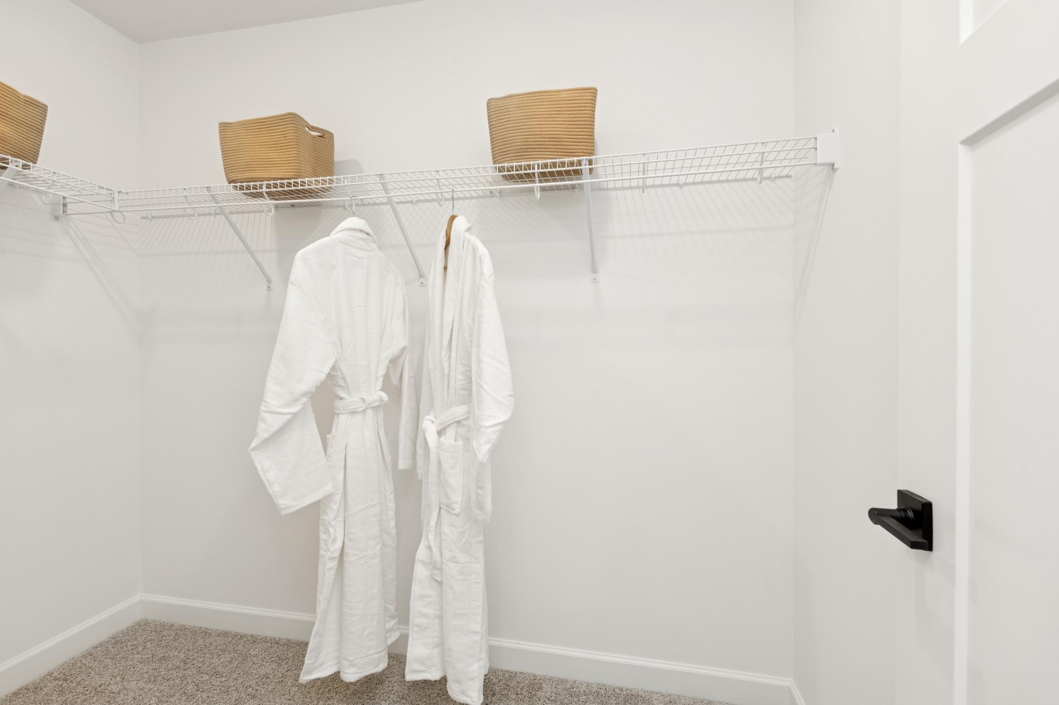 (Photo of Actual Model Home) Wire shelving is included in this large walk-in closet, which provides ample wardrobe space