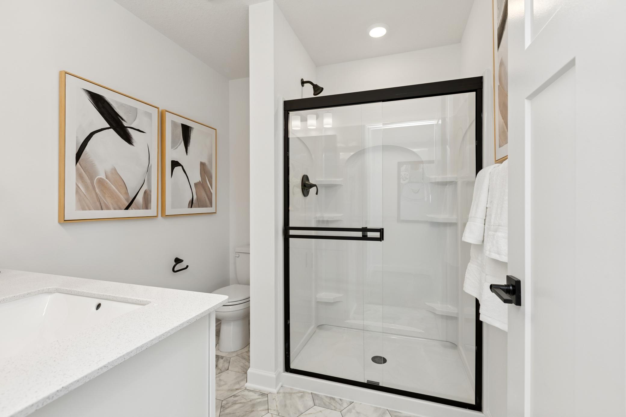 (Photo of Actual Model Home) Another bathroom located on the lower level!