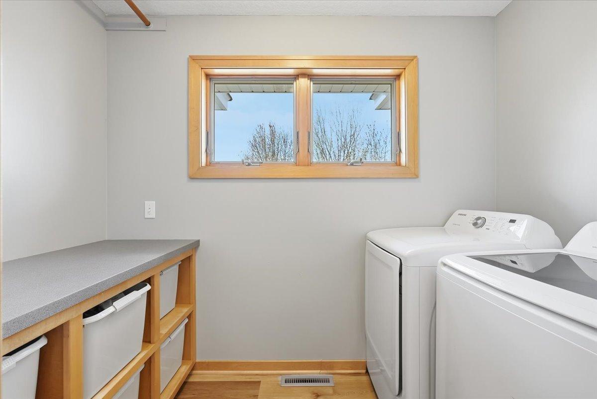This great laundry room has storage, counter space and a door to keep the peace during heavy laundry days