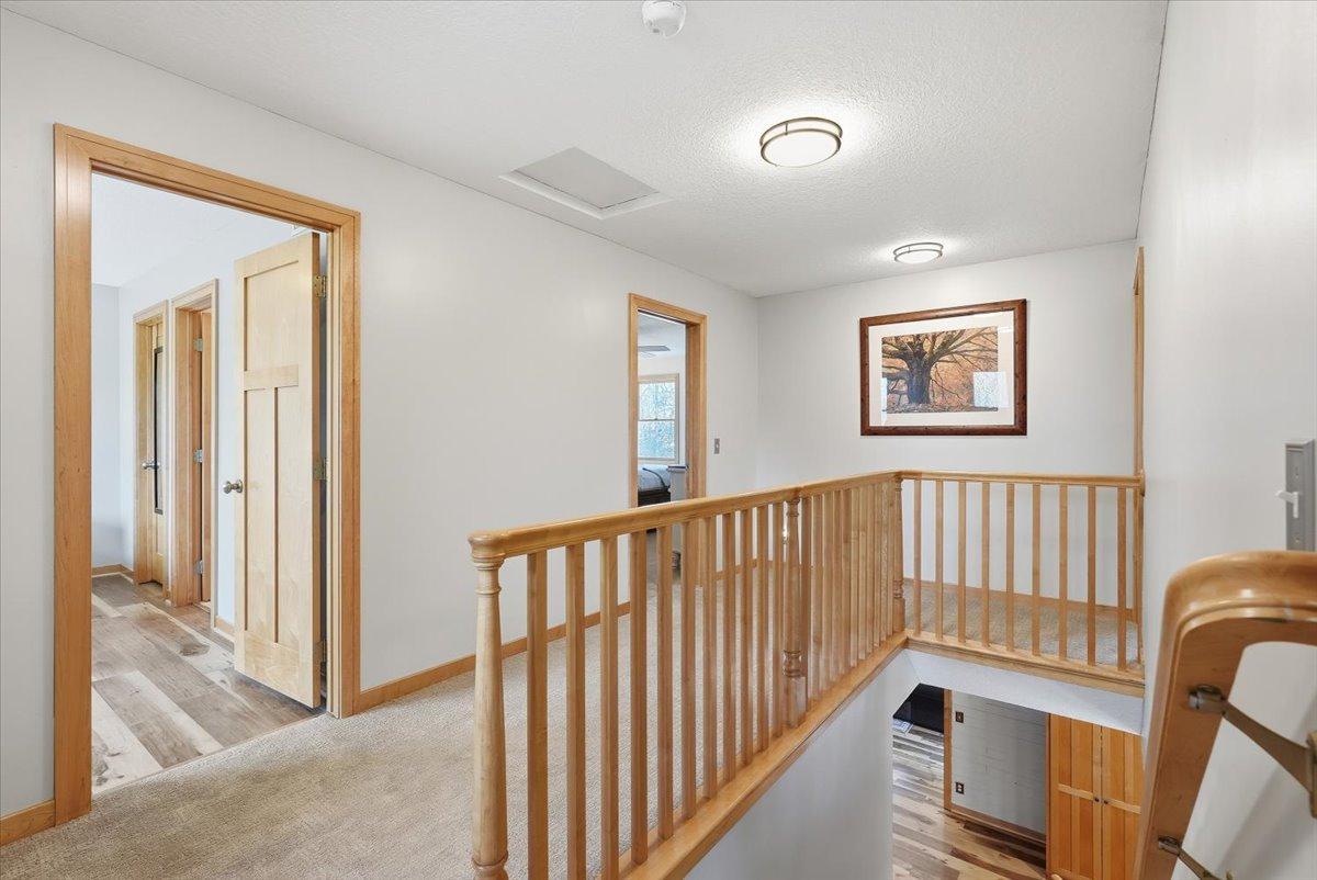 Open staircase to 4 bedrooms, 2 of them being primary bedrooms with en-suite bathrooms