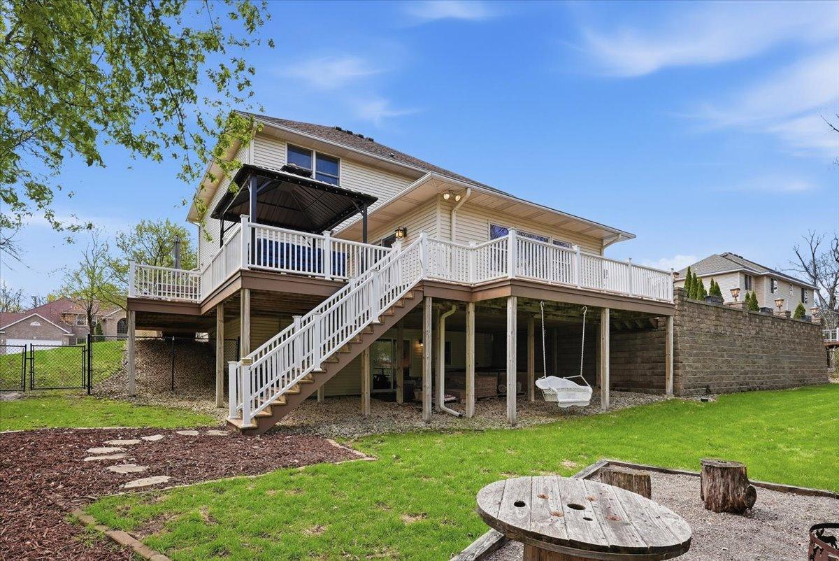 Full view of this stunning wrap-around deck overlooking the pool and fenced backyard