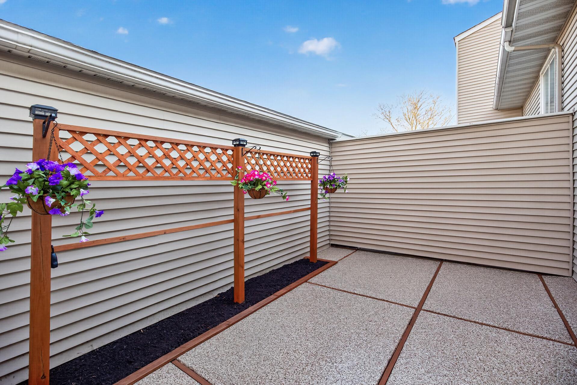 Another view of the secluded courtyard patio showcasing added privacy and outdoor entertaining space.