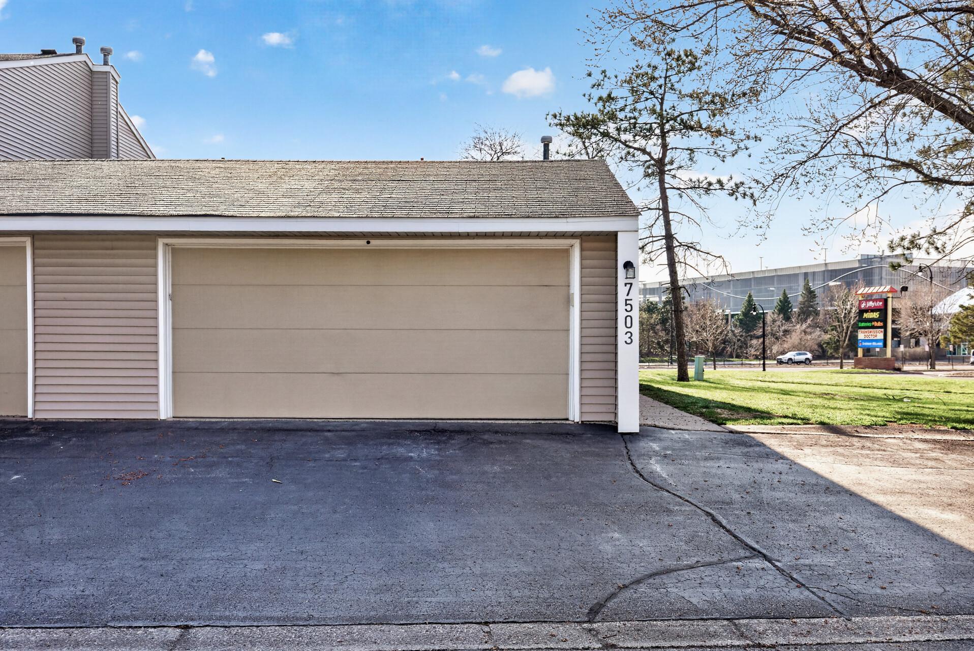 Front view of the spacious garage with private entry nearby and easy access to the home.