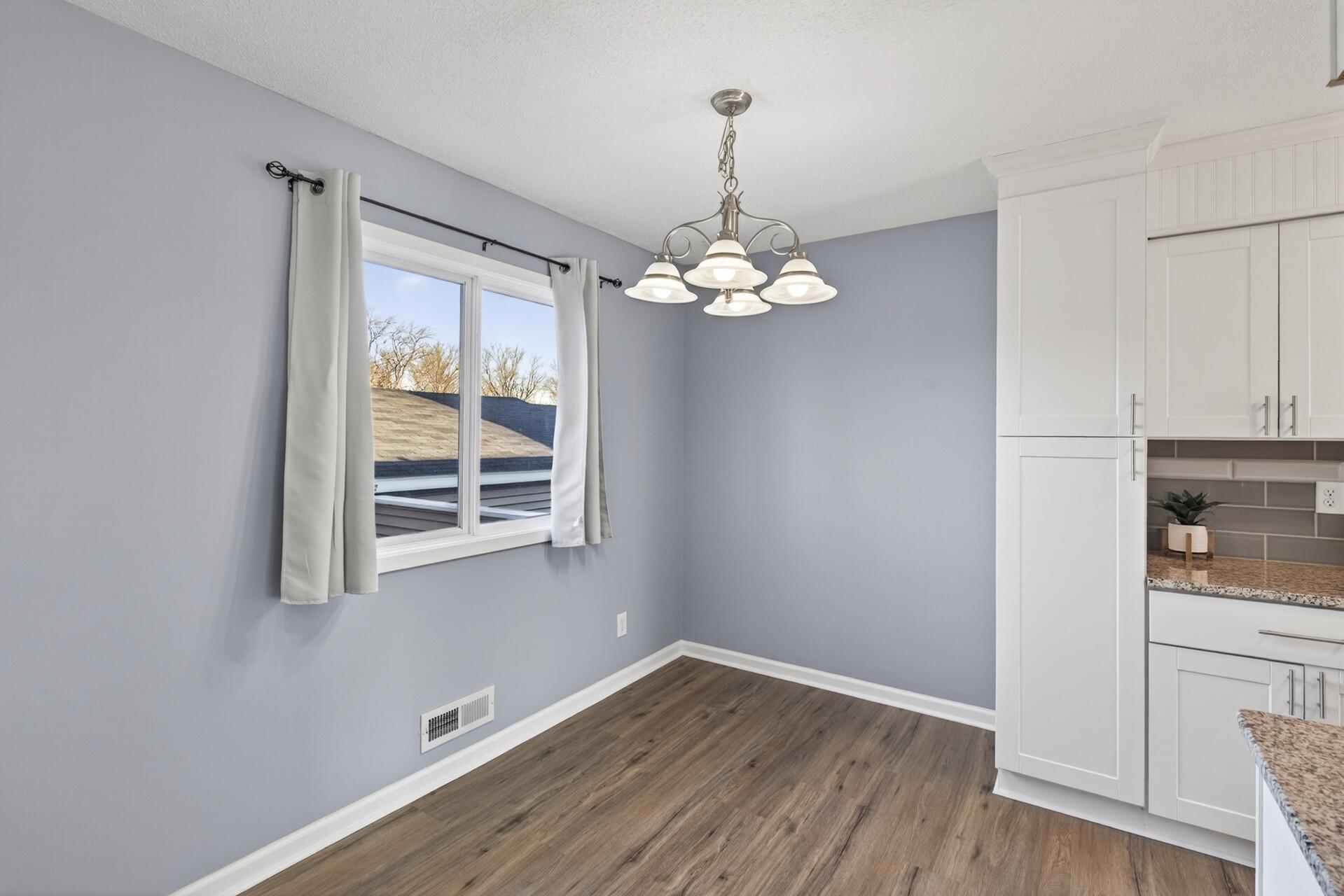 Dining space adjacent to the kitchen featuring modern lighting and easy flow for meals or entertaining.