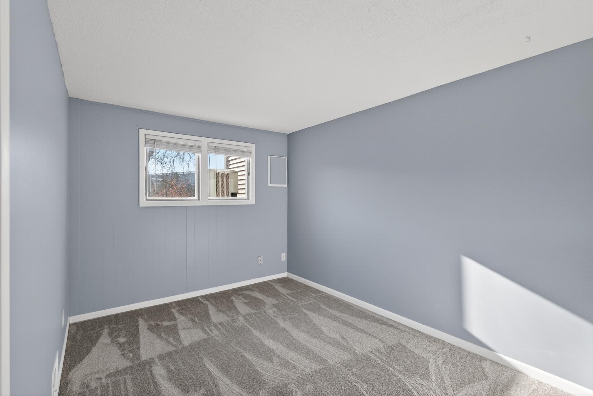 Spacious lower-level family room with plush new carpet, neutral finishes, and flexible space for relaxing, work, or hobbies.