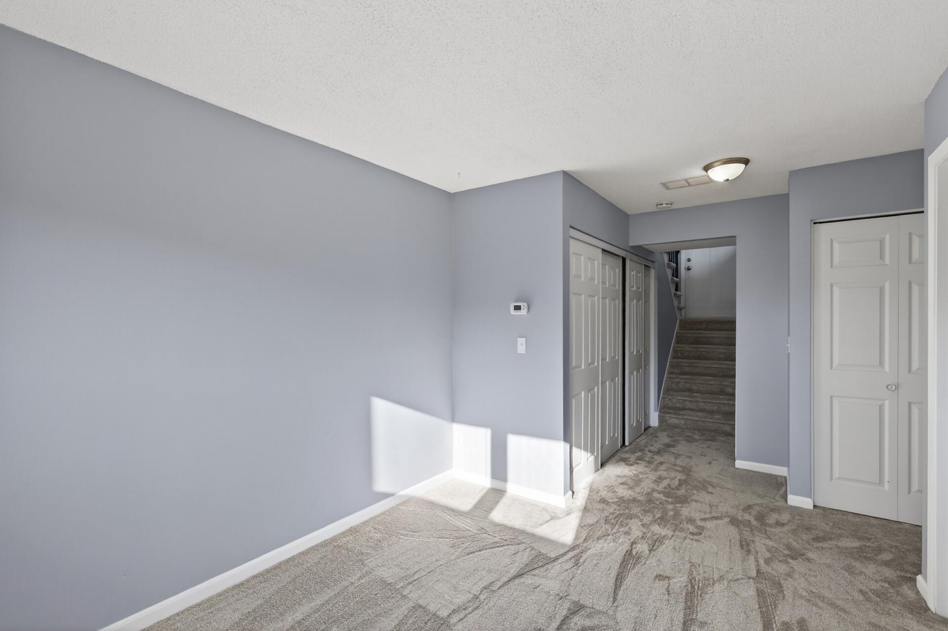 Lower-level family room featuring abundant natural light, fresh updates, and access to bedrooms, bath, and laundry.