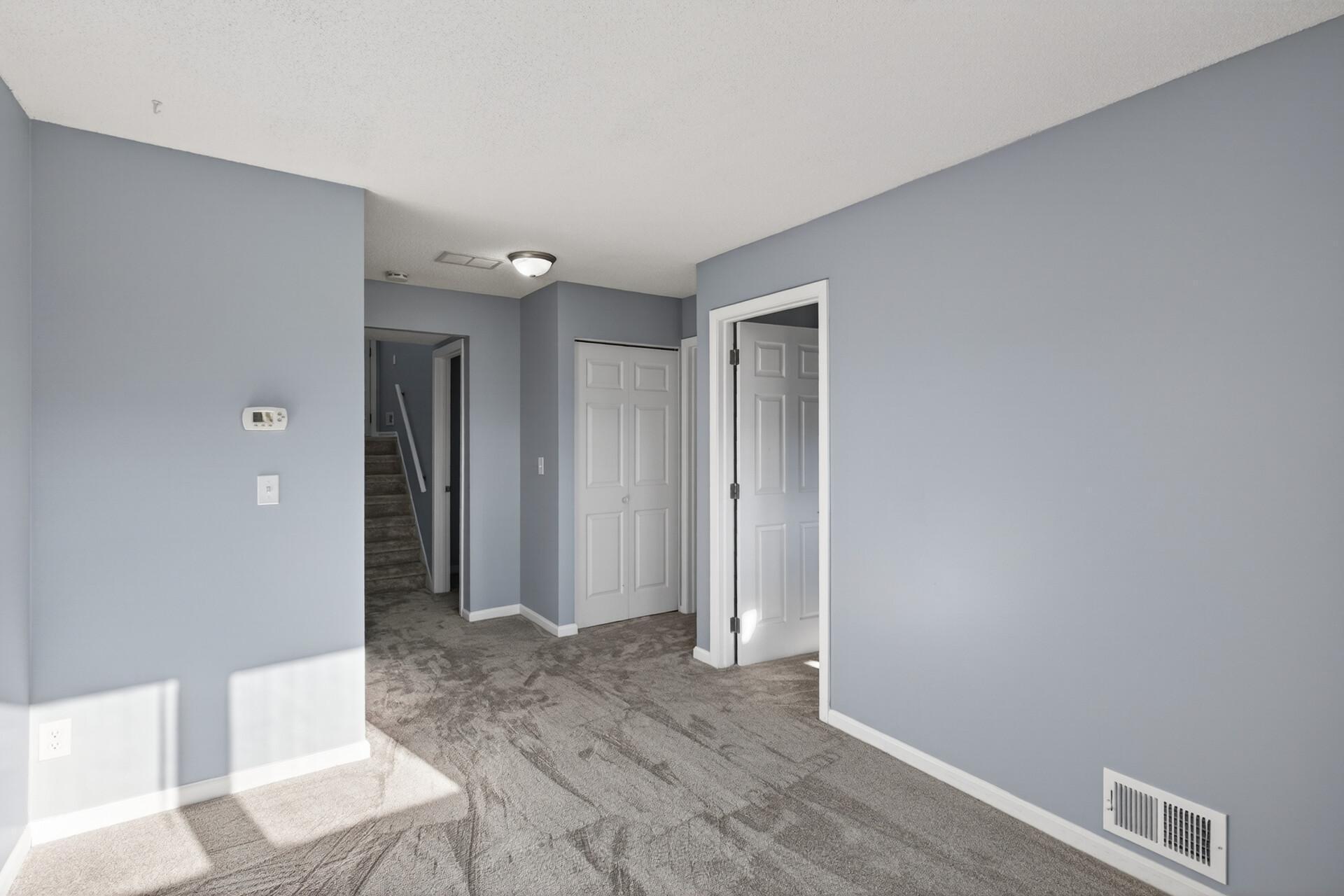 Lower-level family room featuring abundant natural light, fresh updates, and access to bedrooms, bath, and laundry.