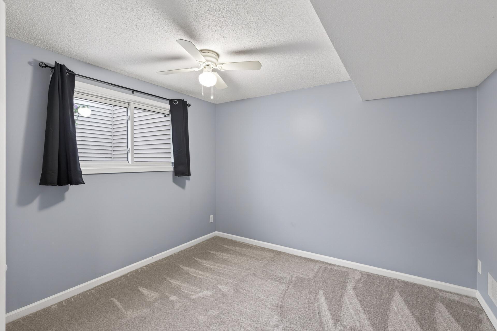 Primary bedroom with lots of space, looking out to the courtyard.
