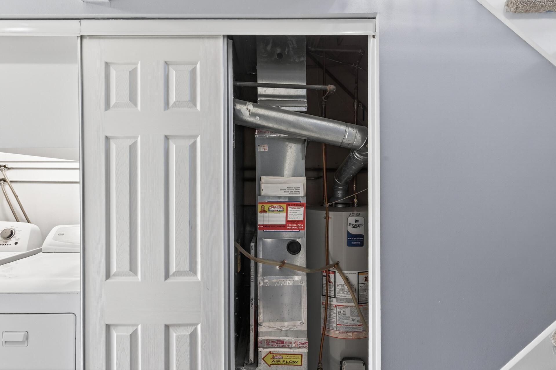 Utility/mechanical area with easy access to furnace and water heater for maintenance and storage convenience.