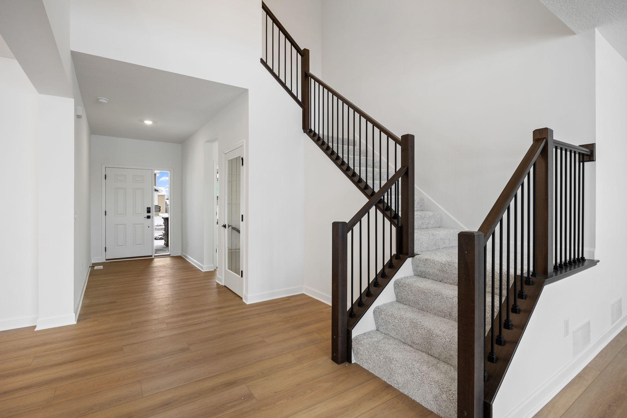 (Photo of a similar home, actual finishes may vary) The kitchen is just behind the Great Room, making it easy to quickly grab snacks and drinks while watching movies or on the go