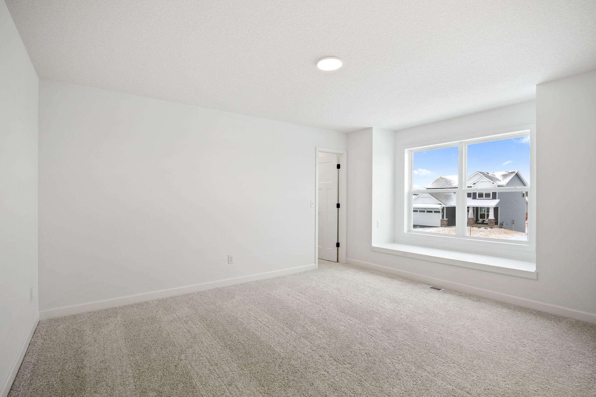 (Photo of a similar home, actual finishes may vary) The home includes a number of bedrooms to accommodate residents looking for extra space.