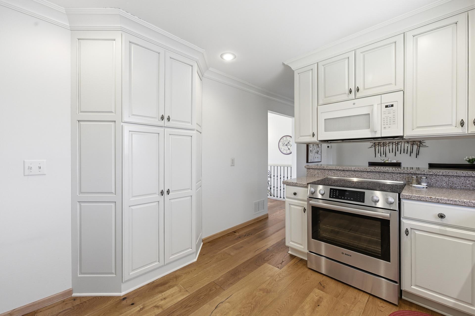 Pantry cabinets across from sink.