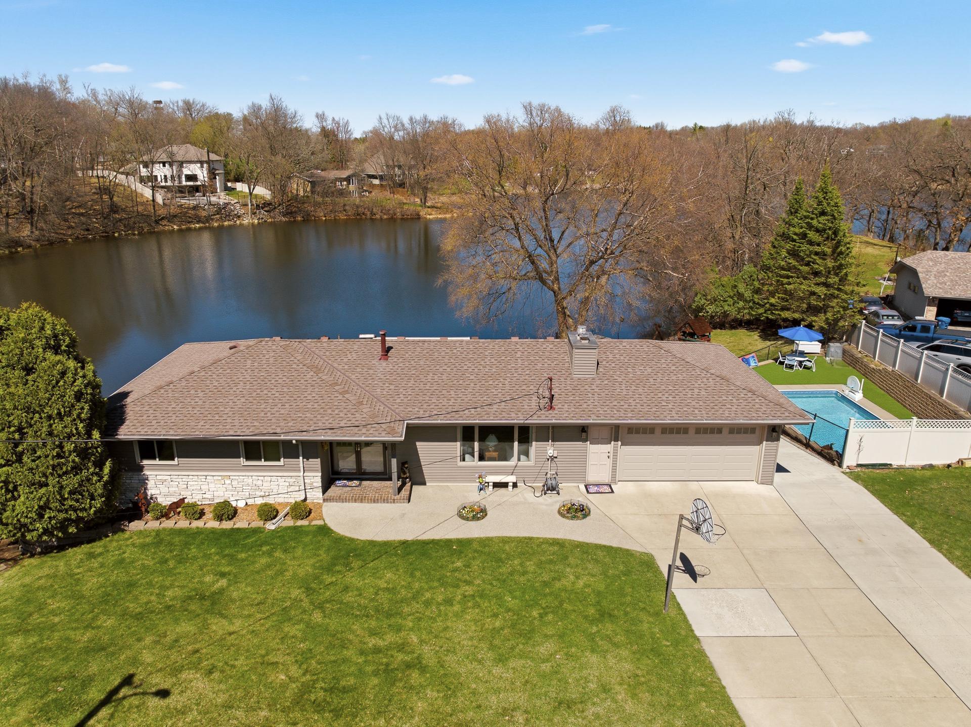 Welcome to 13010 Sunset Trail, Plymouth. The home is beautifully situated on a private 1.65 acre lot overlooking Cavanaugh Lake with 240' of lake shore.