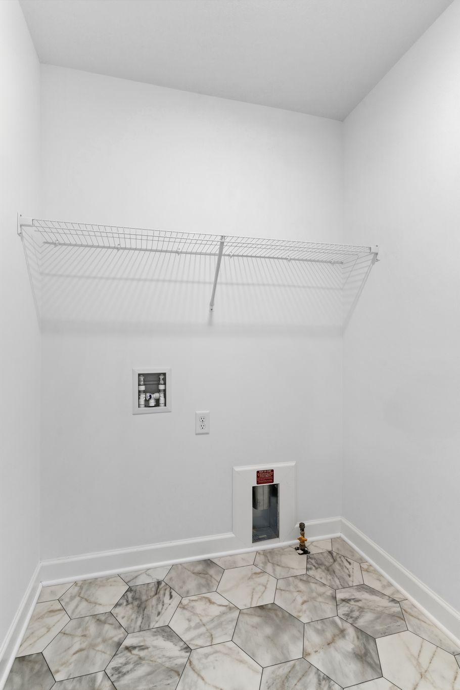 Enjoy simple chore days with a ventilated shelf and washer-dryer connections in the laundry room.