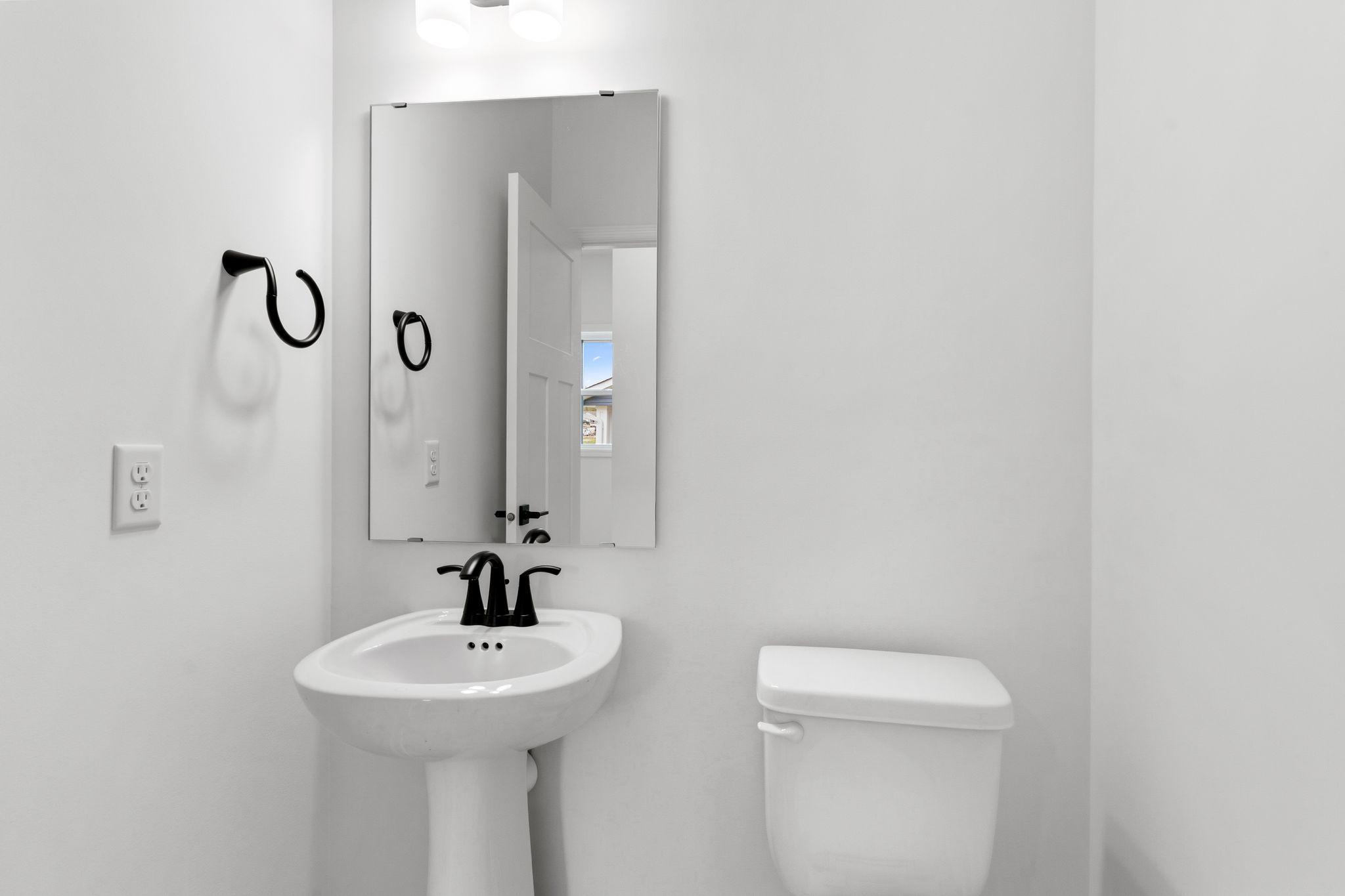 The powder room is easily accessible from the communal living spaces.