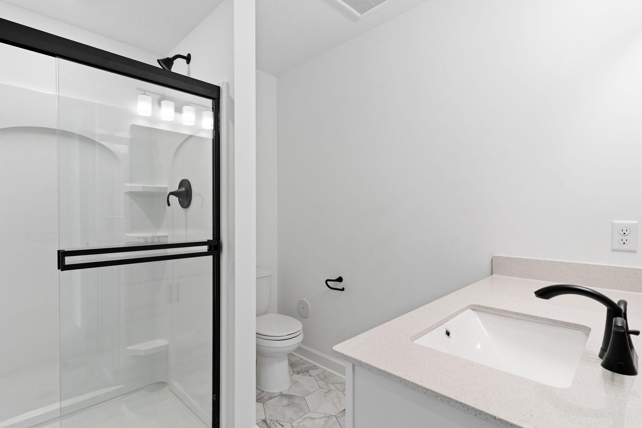 This 3/4 bath, located in the basement, is adjacent to the fifth bedroom.