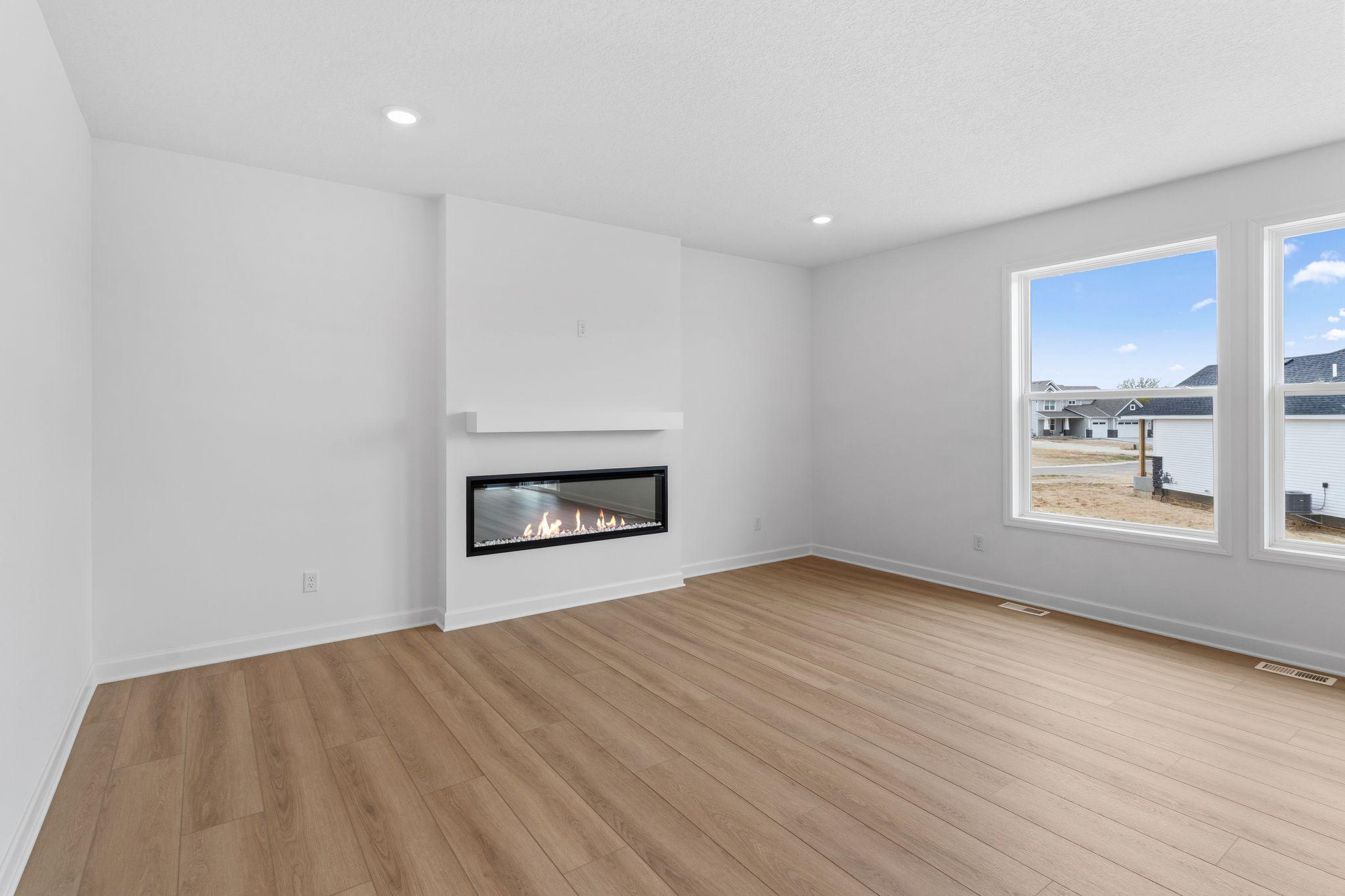 An electric fireplace offers a warm and cozy glow