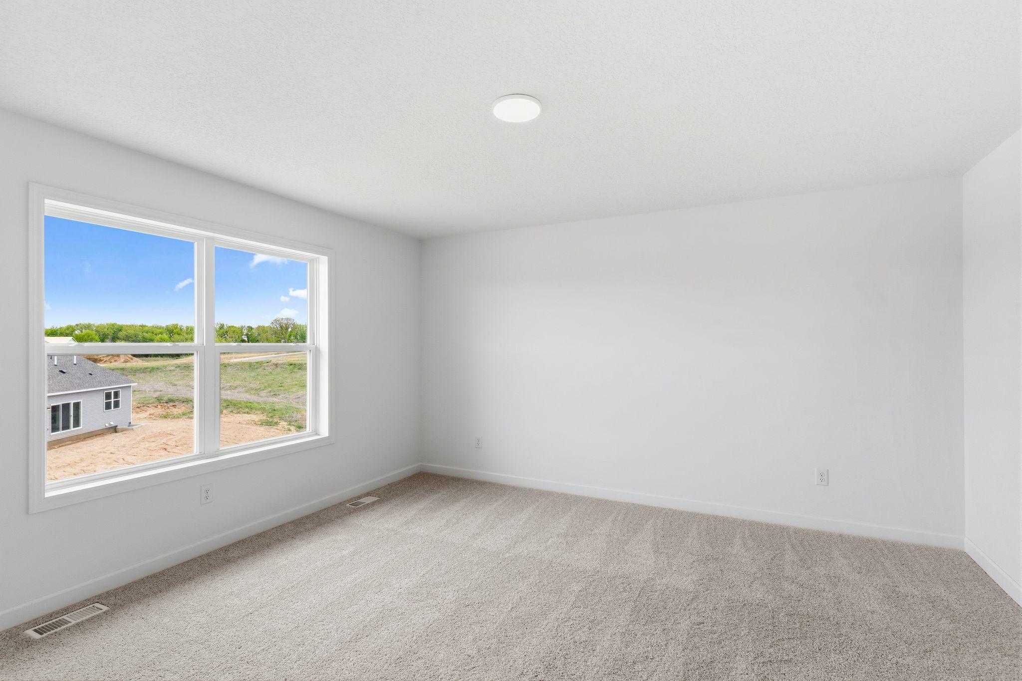 The owner’s suite is situated on the home’s second level, comprised of a restful bedroom, en-suite bathroom and walk-in closet.