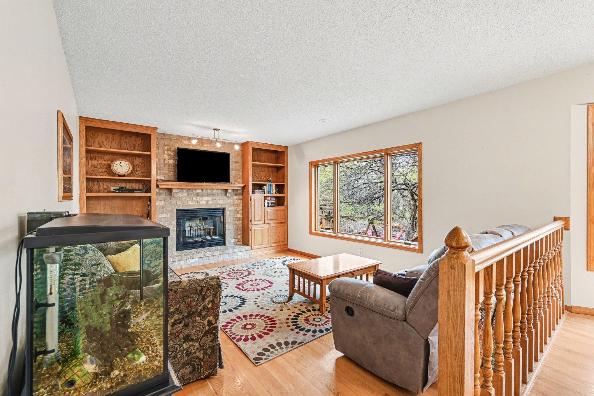 Family room with a wood-burning fireplace create a warm and inviting space.