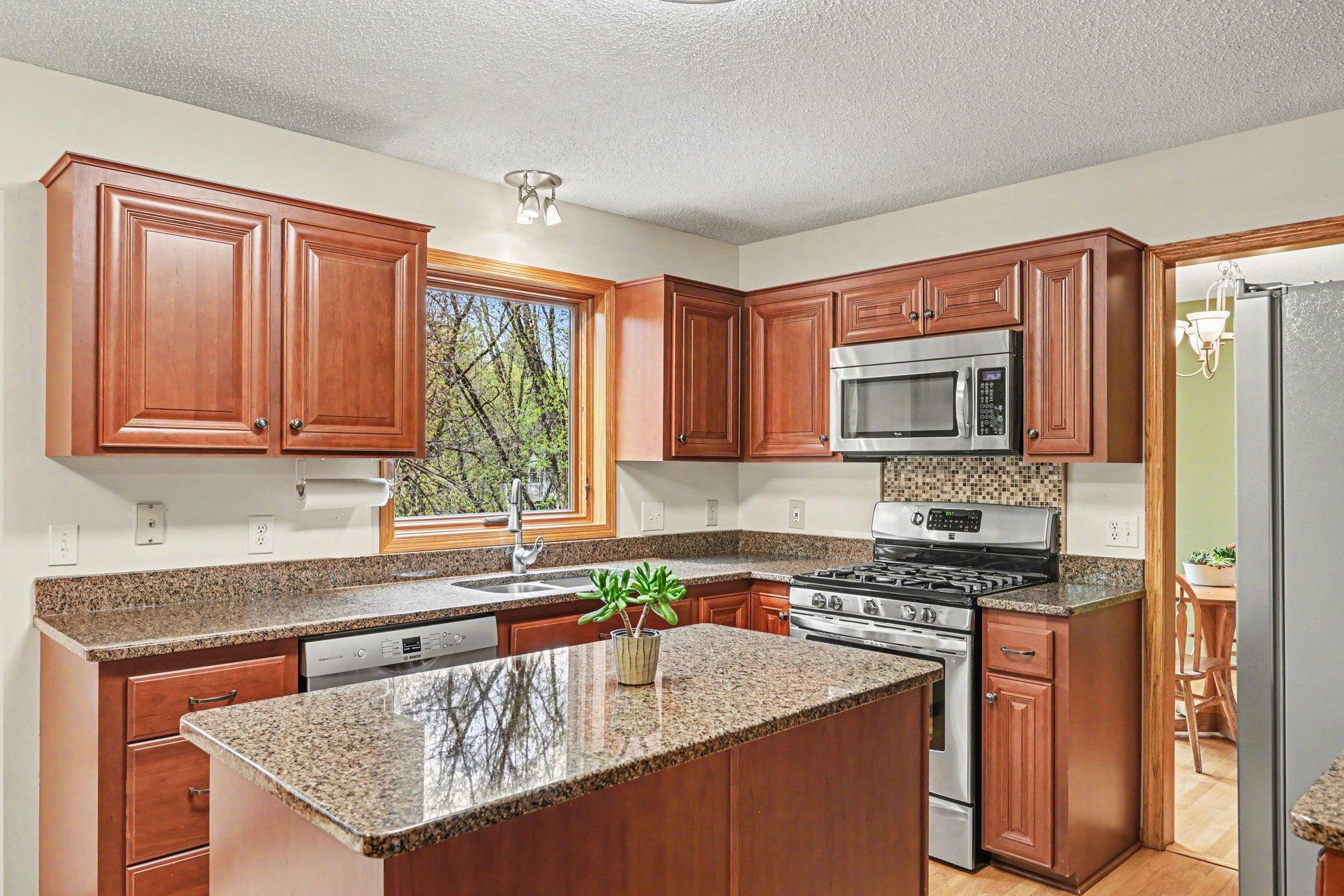 The functional and stylish kitchen offers stainless appliances.
