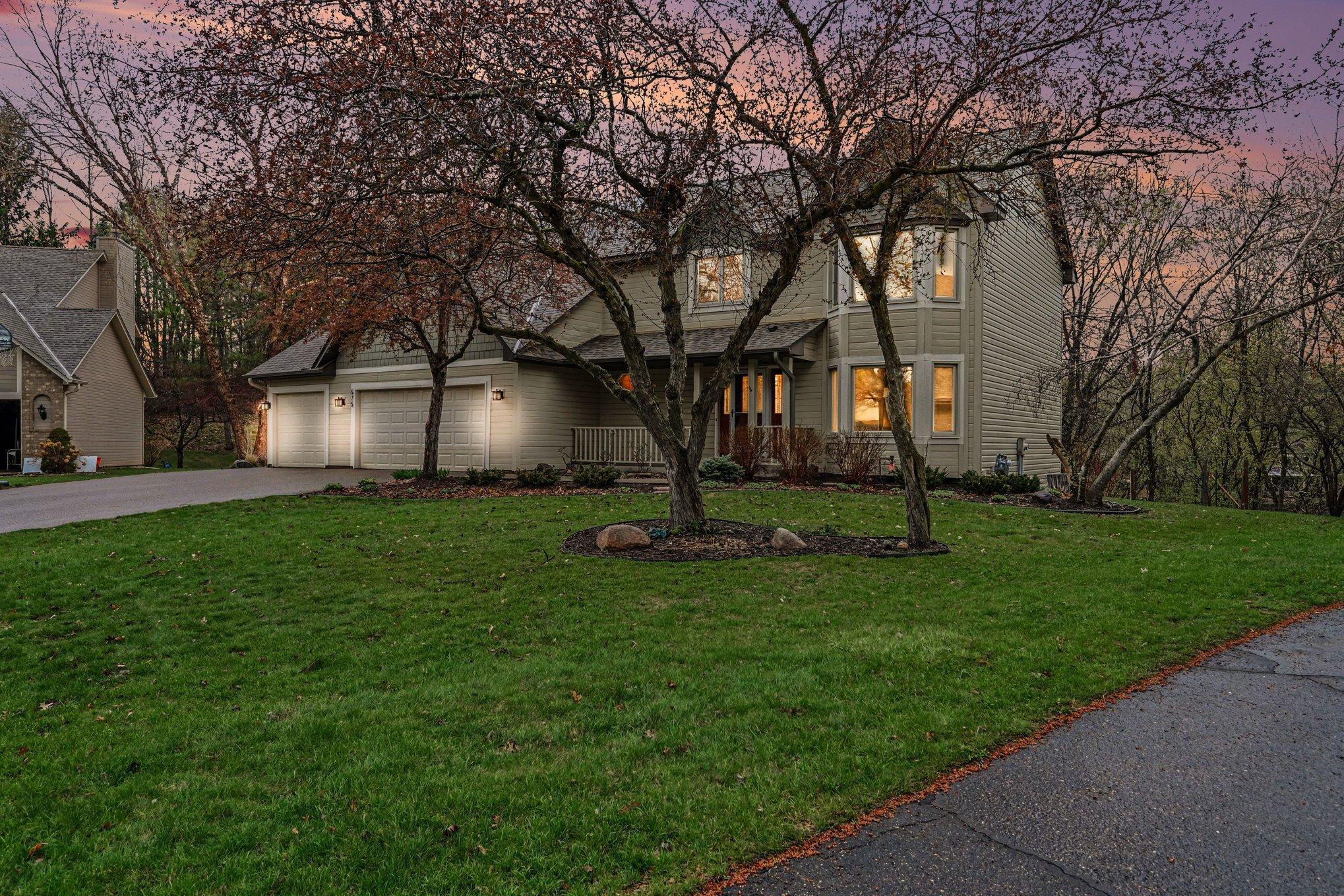 Virtual twilight showcases the home's inviting curb appeal.