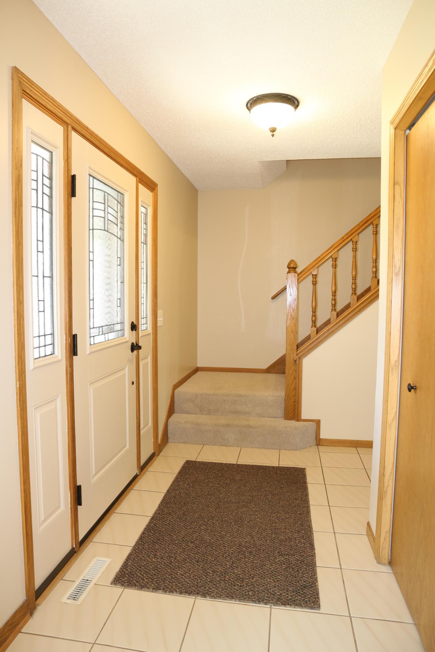 Front entry features a door with decorative glass and sidelights.