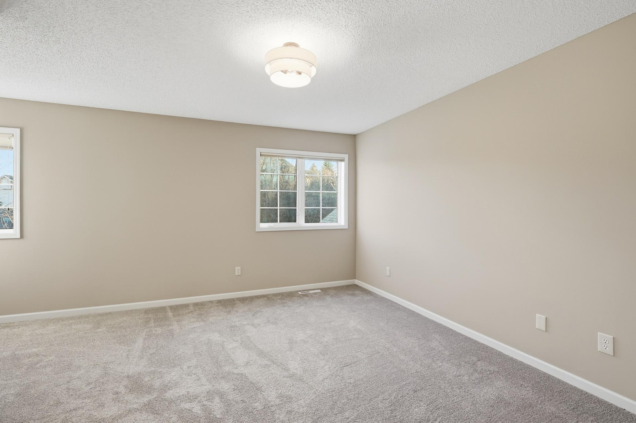 Oversized Bedroom on upper level with a walk in closet and 2 large windows and new light..