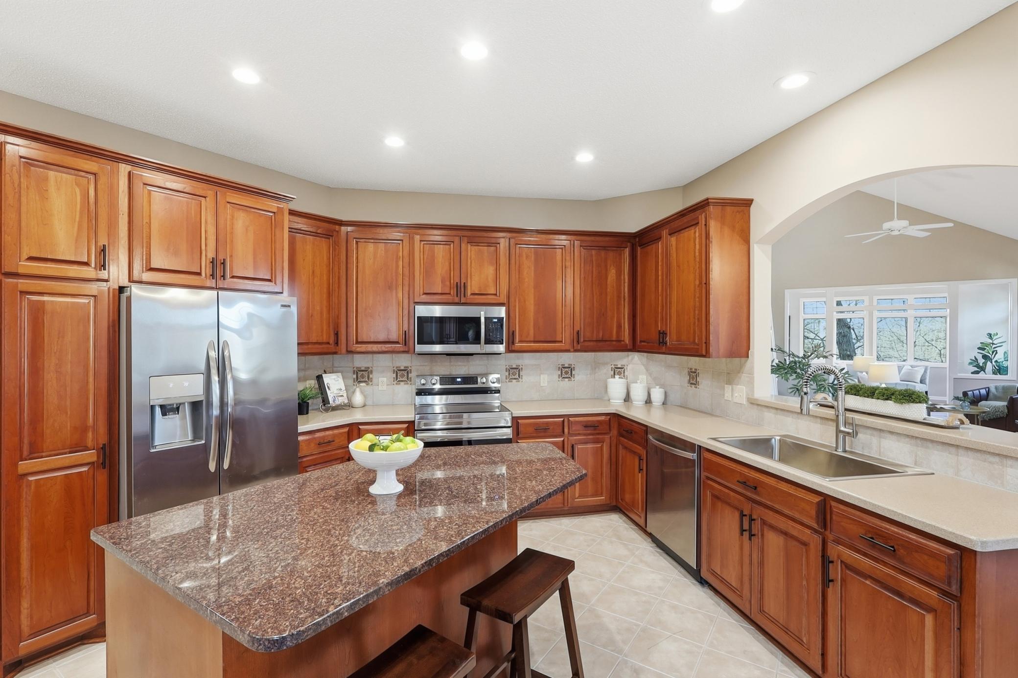 Gourmet kitchen with large granite center island, and gorgeous cherry cabinetry.