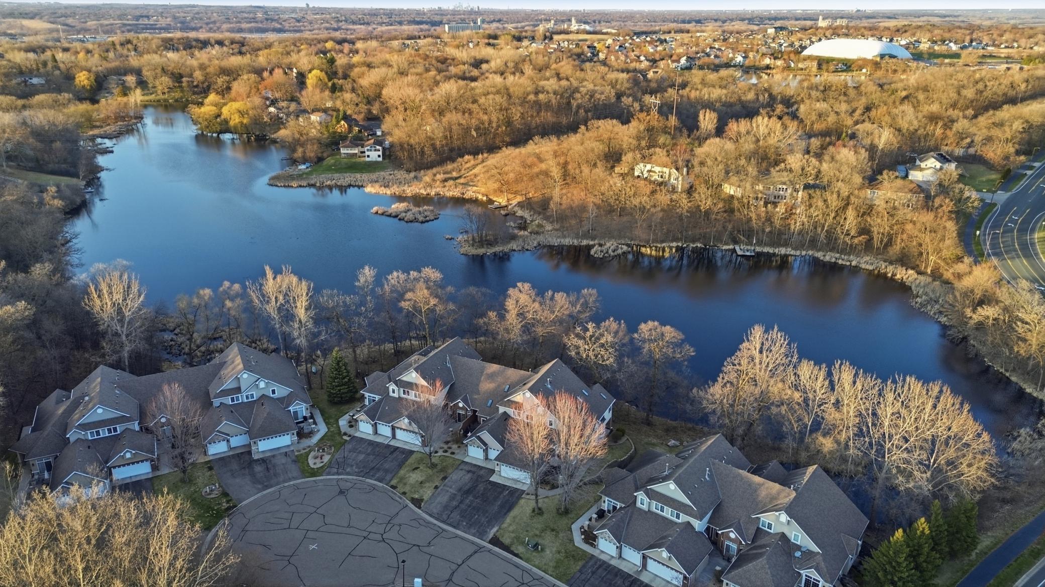 Welcome to this updated end-unit townhome with lake views, main-level living, open floor plan, sunroom, and walkout lower level.