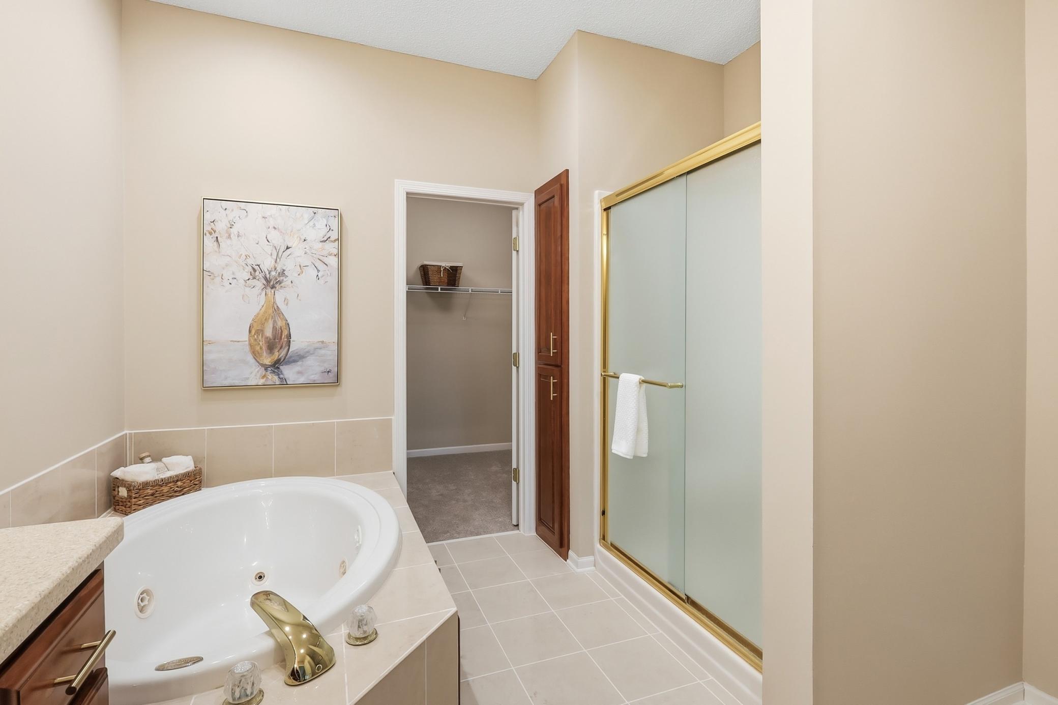 Enjoy a large walk in closet and updated lighting and mirrors.