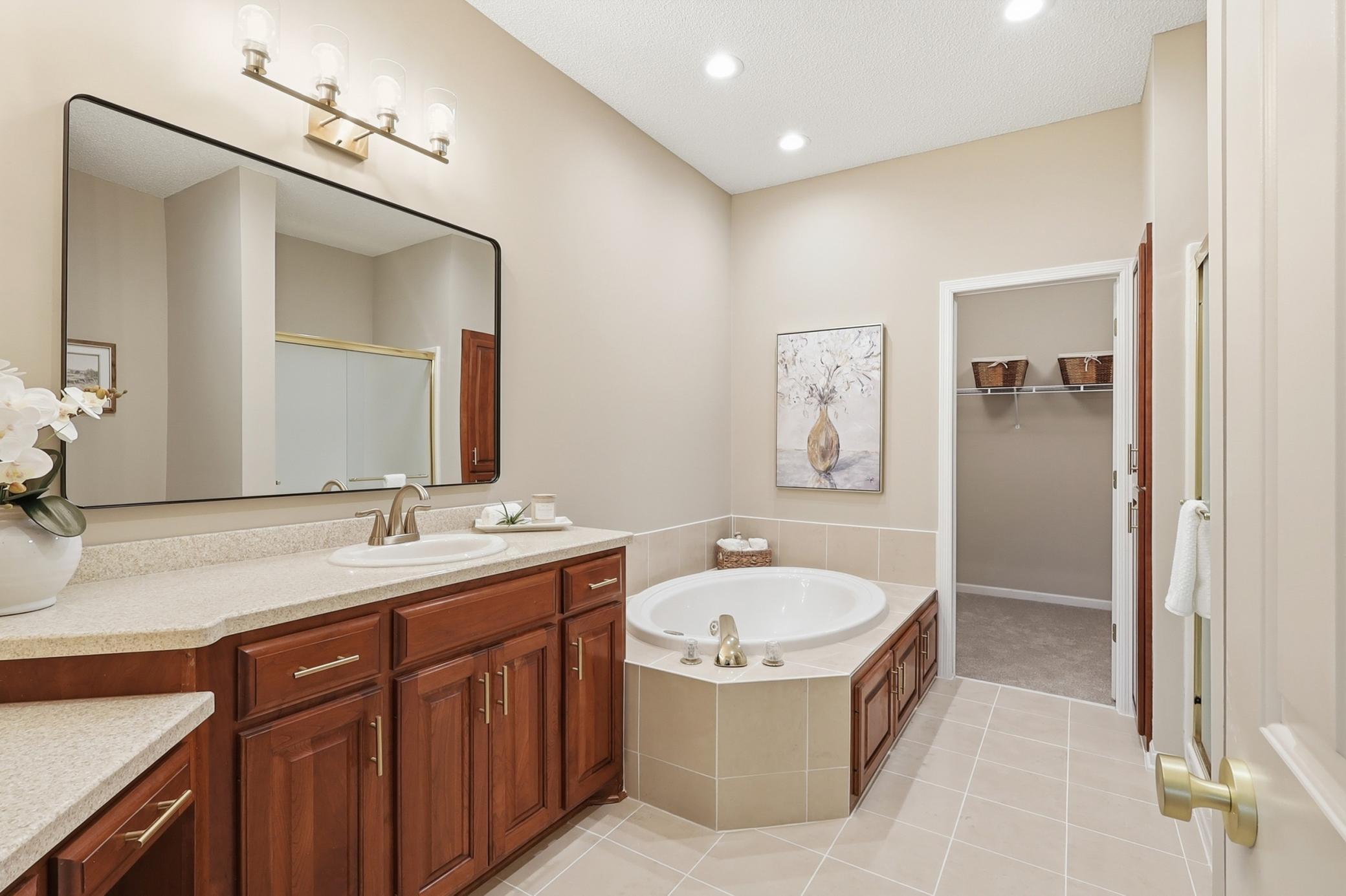 This primary bath is oversized and offers a vanity area, separate shower and tub.