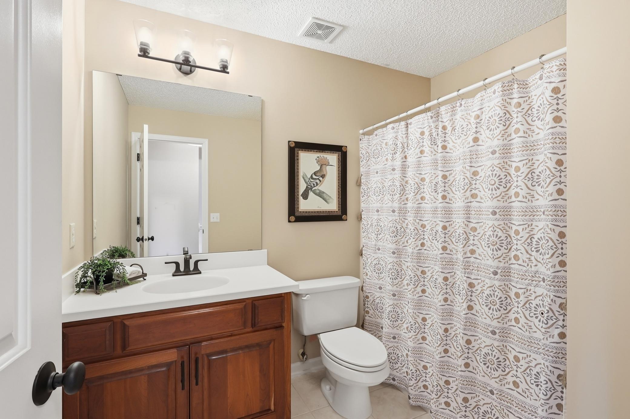 Upper level full bath with updated faucet and lights.