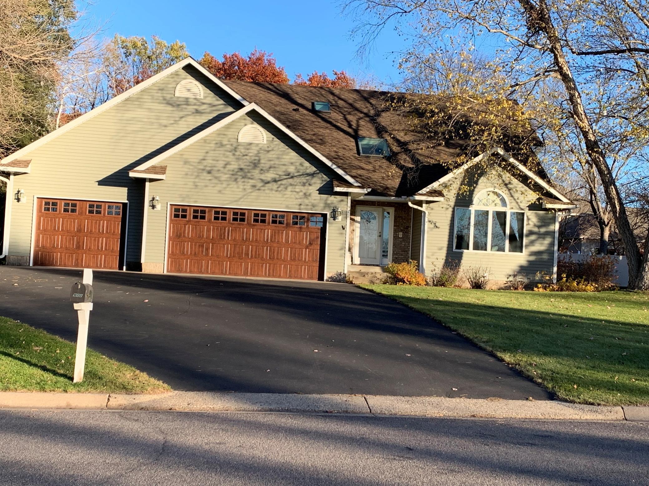 The exterior of this well maintained home has new shingles, new steel siding, and new garage doors.