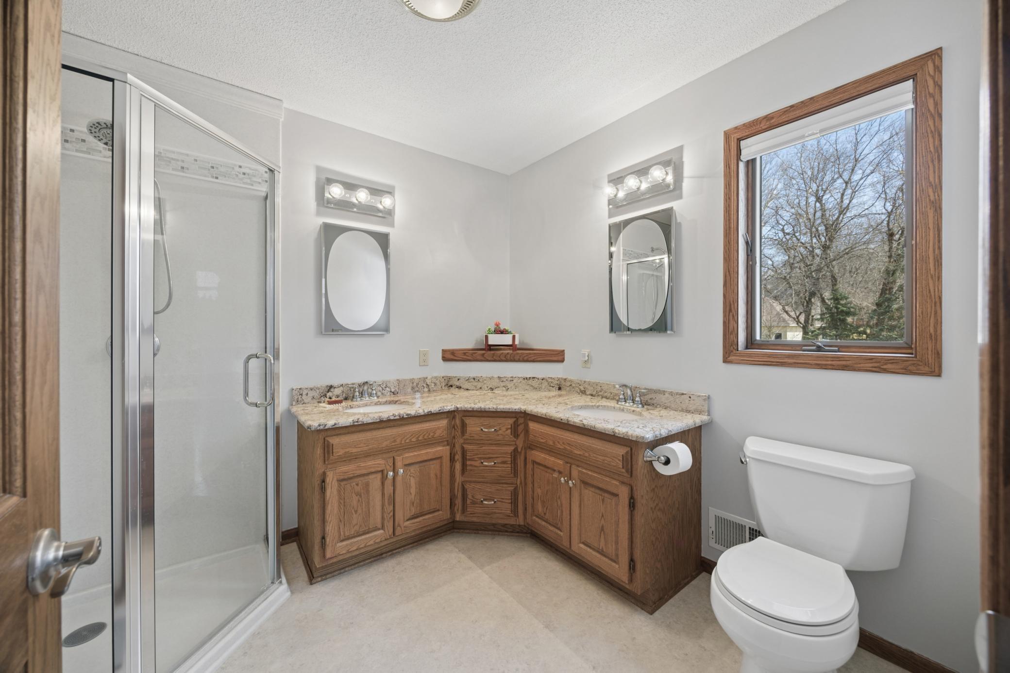 Bathroom with shower in primary suite.