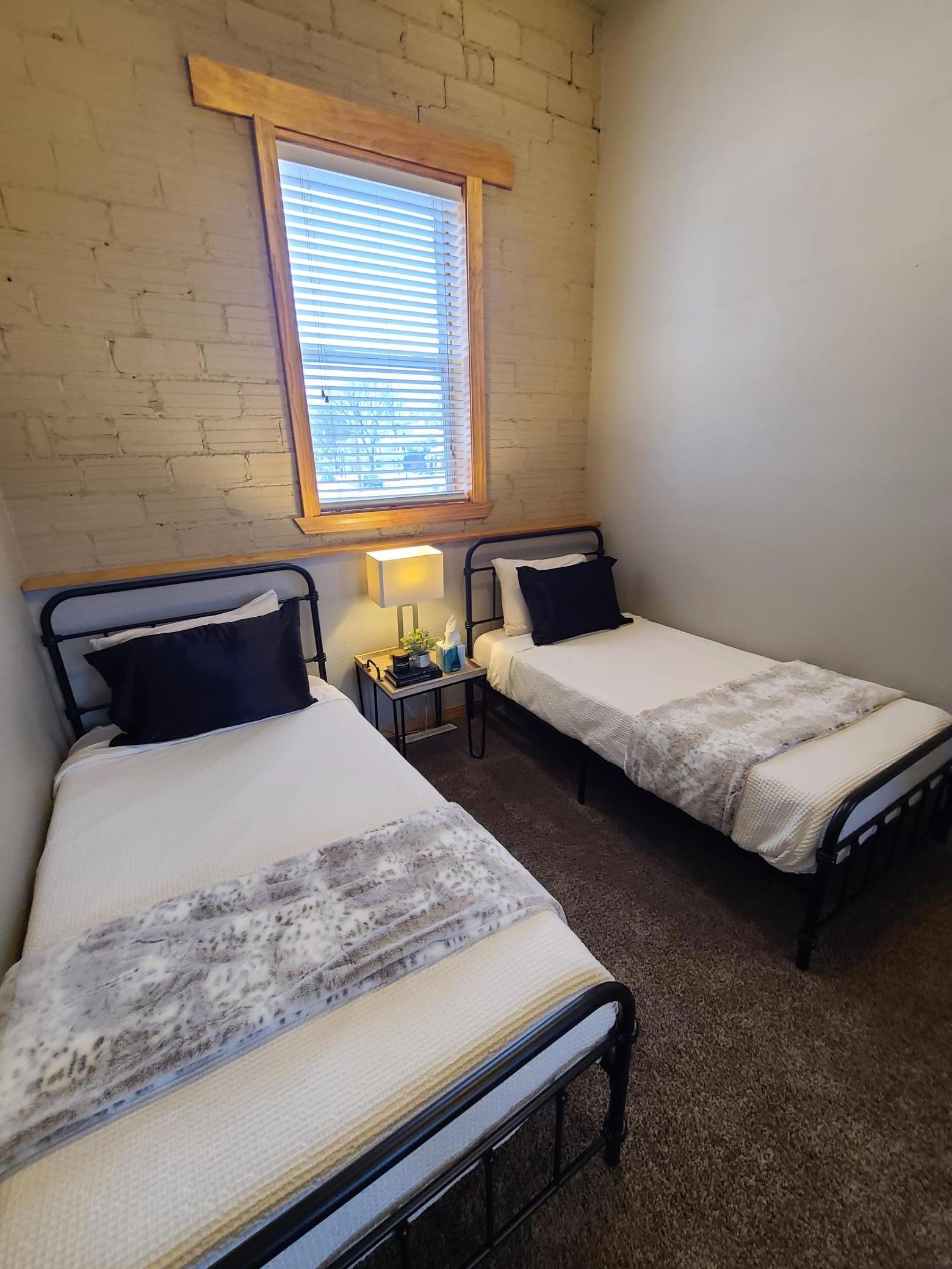 Bedroom 1 view 2, exposed brick wall