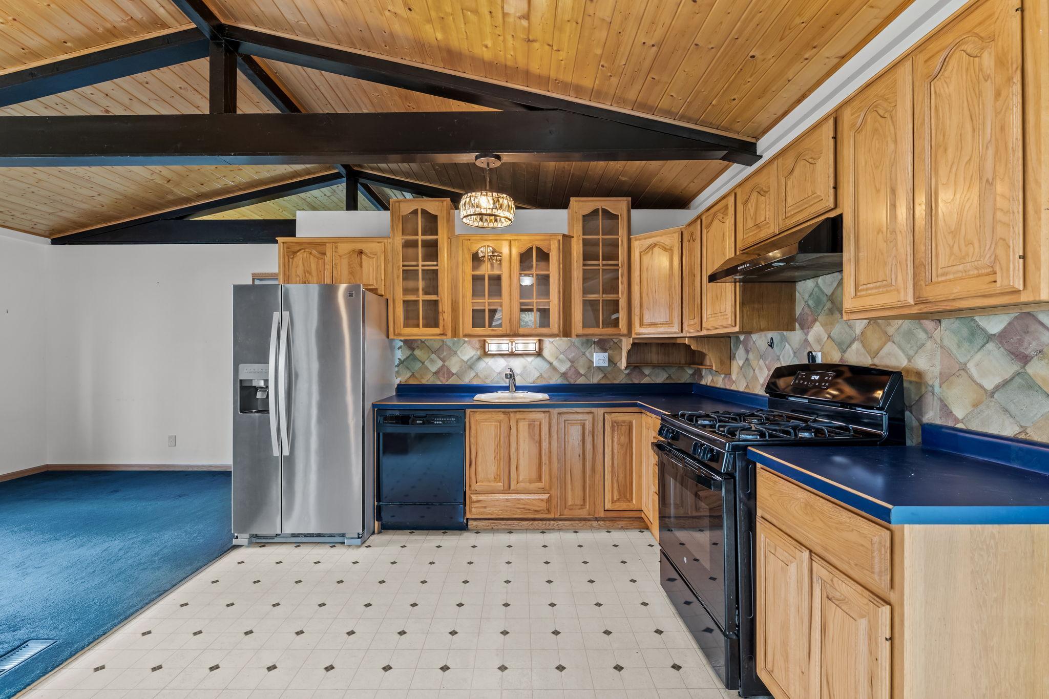 Huge open kitchen with gorgeous tongue and groove vaulted ceilings, updated appliances and beautiful oak cabinets.