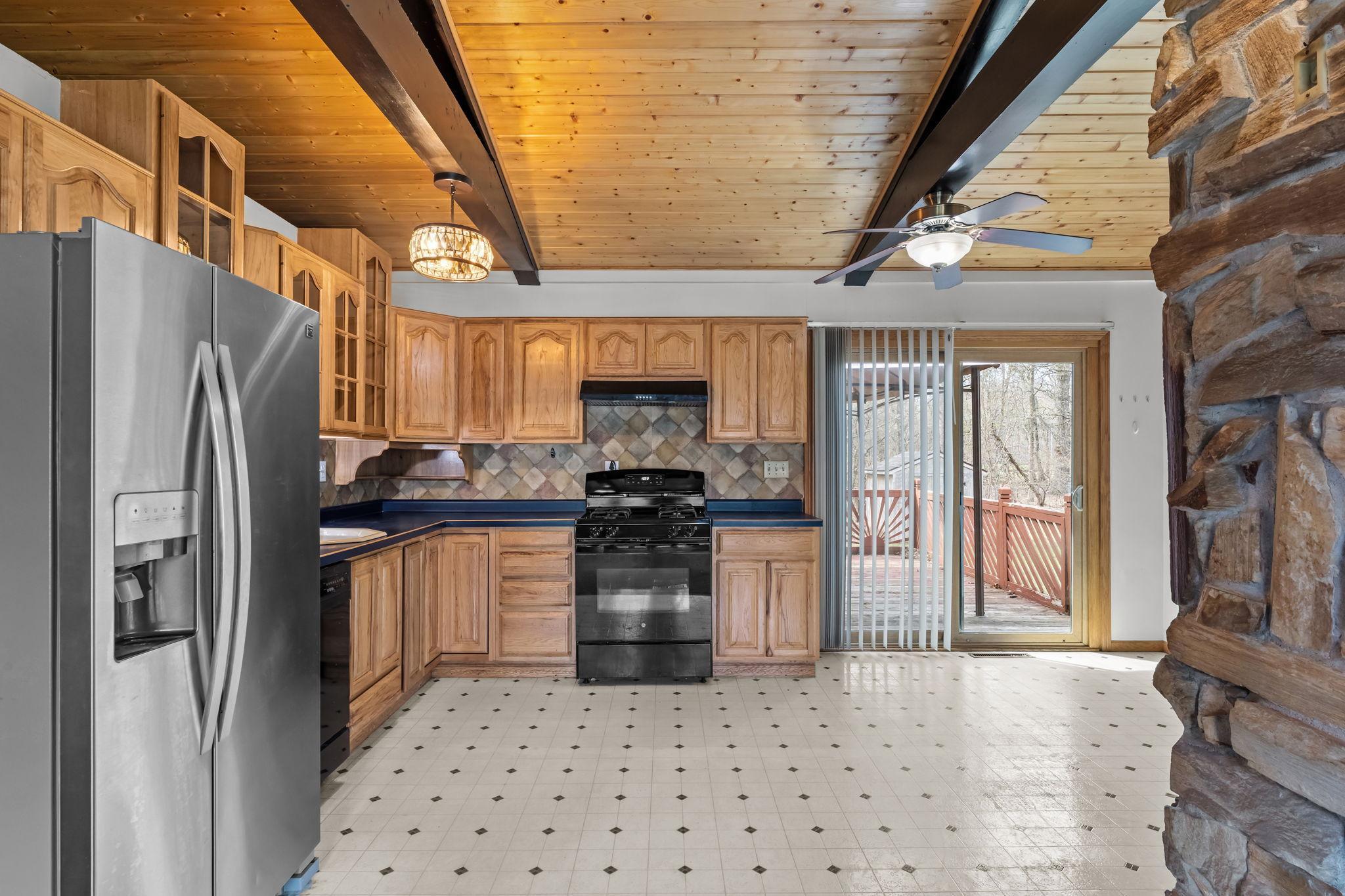 The huge eat in kitchen opens up to the back yard patio.