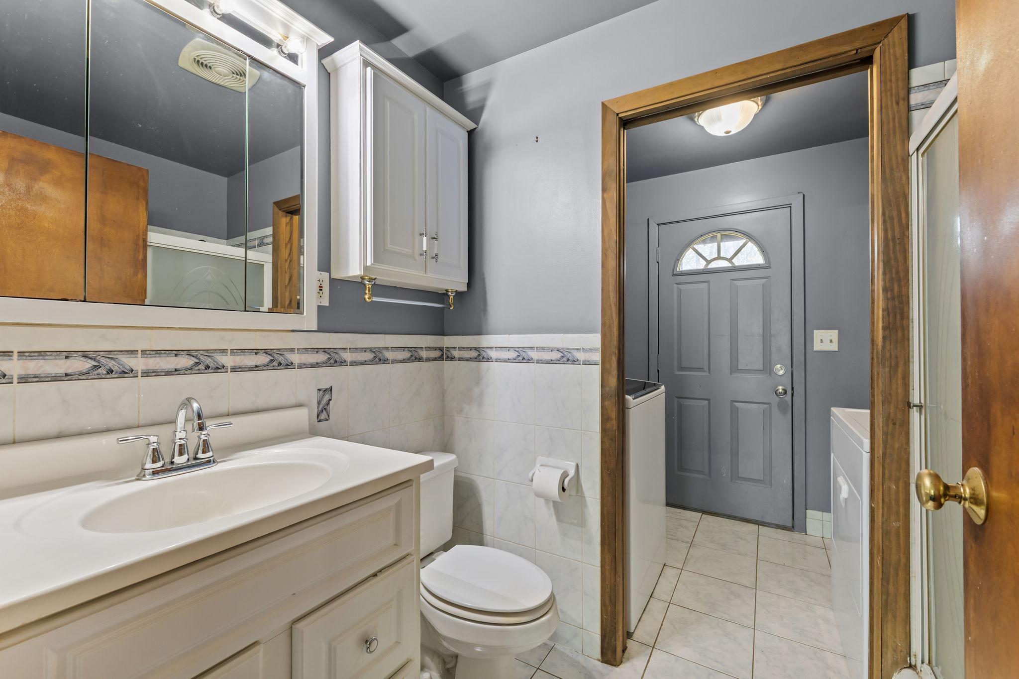 Main floor full bathroom opens up to the laundry room.